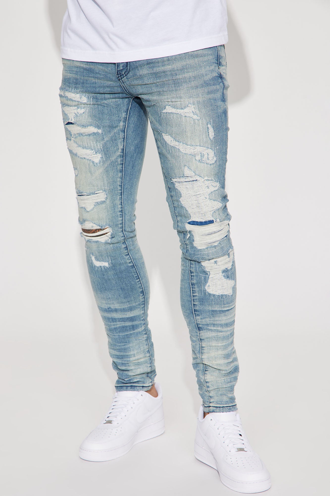 Fame Frenzy: Light Wash Paint-Spotted Stacked Skinny Jeans