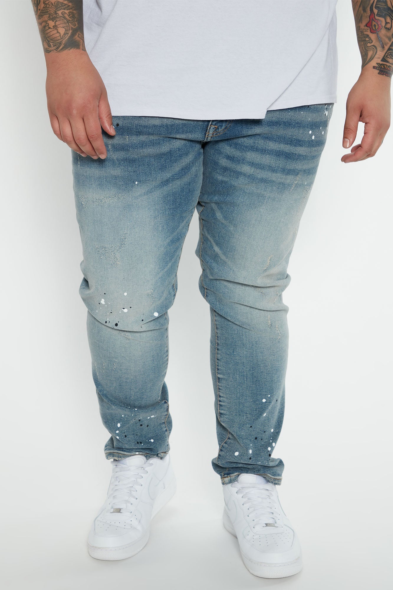 Edgy and Trendy: Ripped and Bleach Splatter Slim Jeans in Light Blue Wash