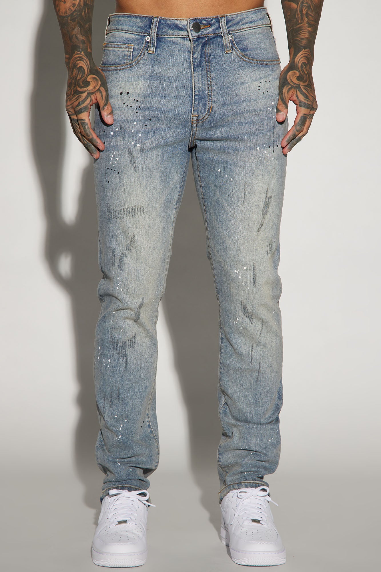 Edgy and Trendy: Ripped and Bleach Splatter Slim Jeans in Light Blue Wash