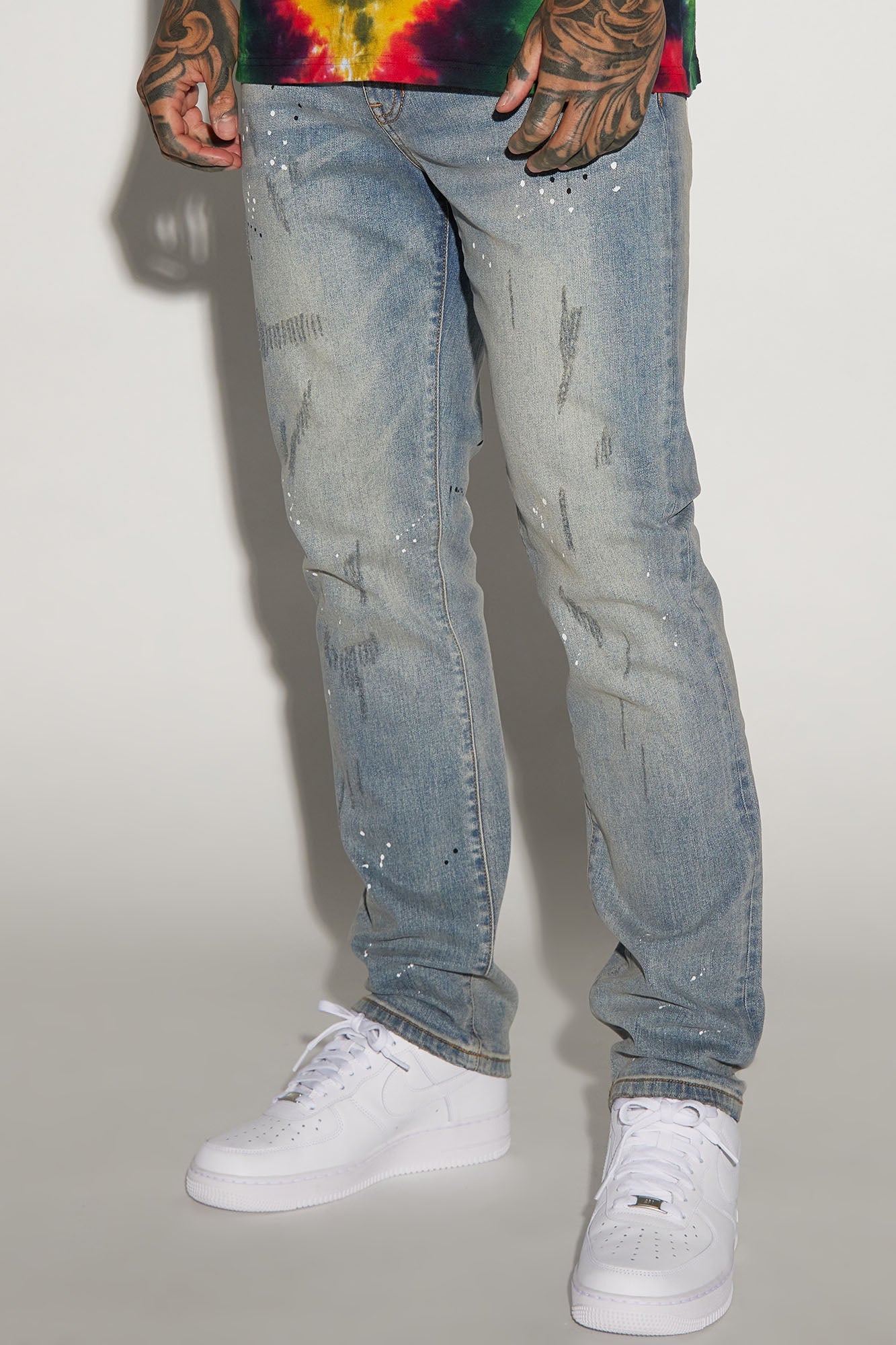 Edgy and Trendy: Ripped and Bleach Splatter Slim Jeans in Light Blue Wash