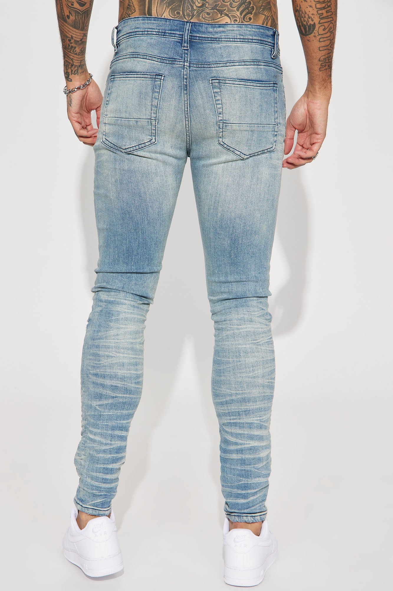 Fame Frenzy: Light Wash Paint-Spotted Stacked Skinny Jeans