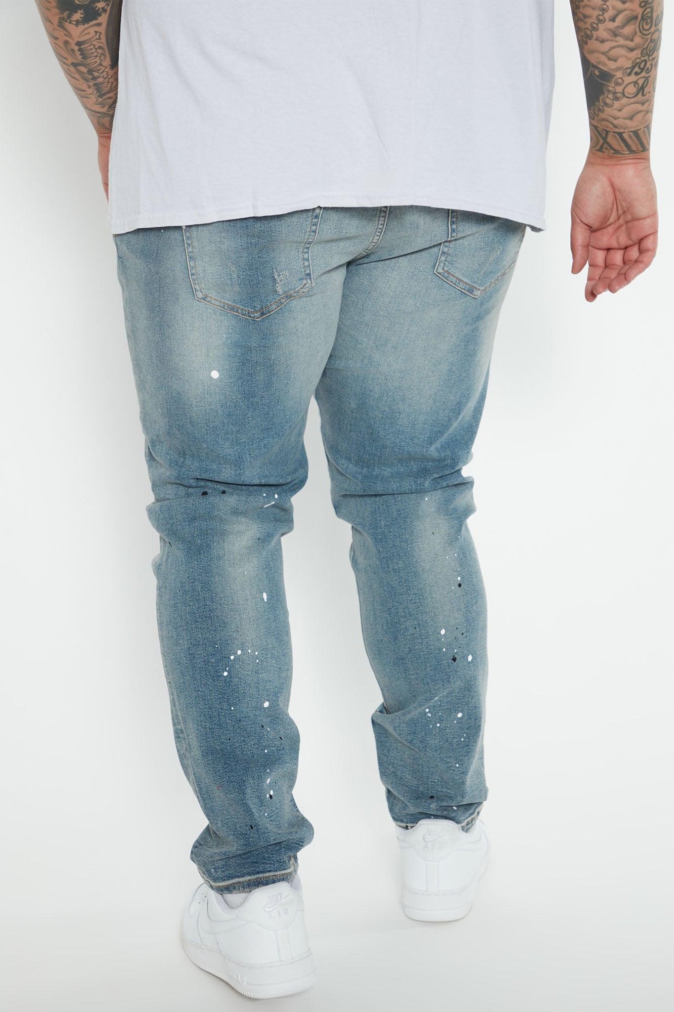 Edgy and Trendy: Ripped and Bleach Splatter Slim Jeans in Light Blue Wash